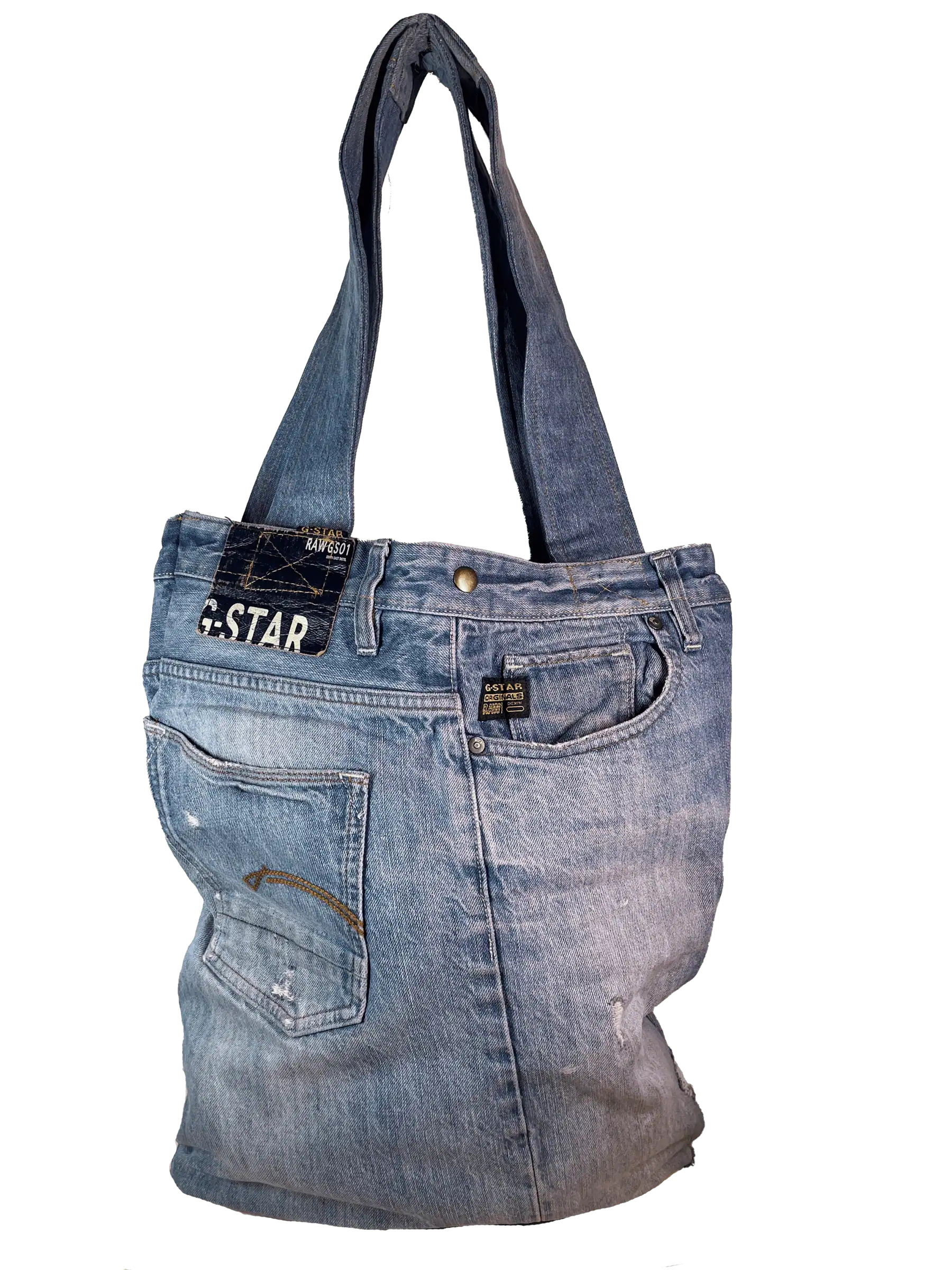 Tote bag constructed from repurposed blue denim jeans against a solid green background highlighting the G-Star Raw text patch
