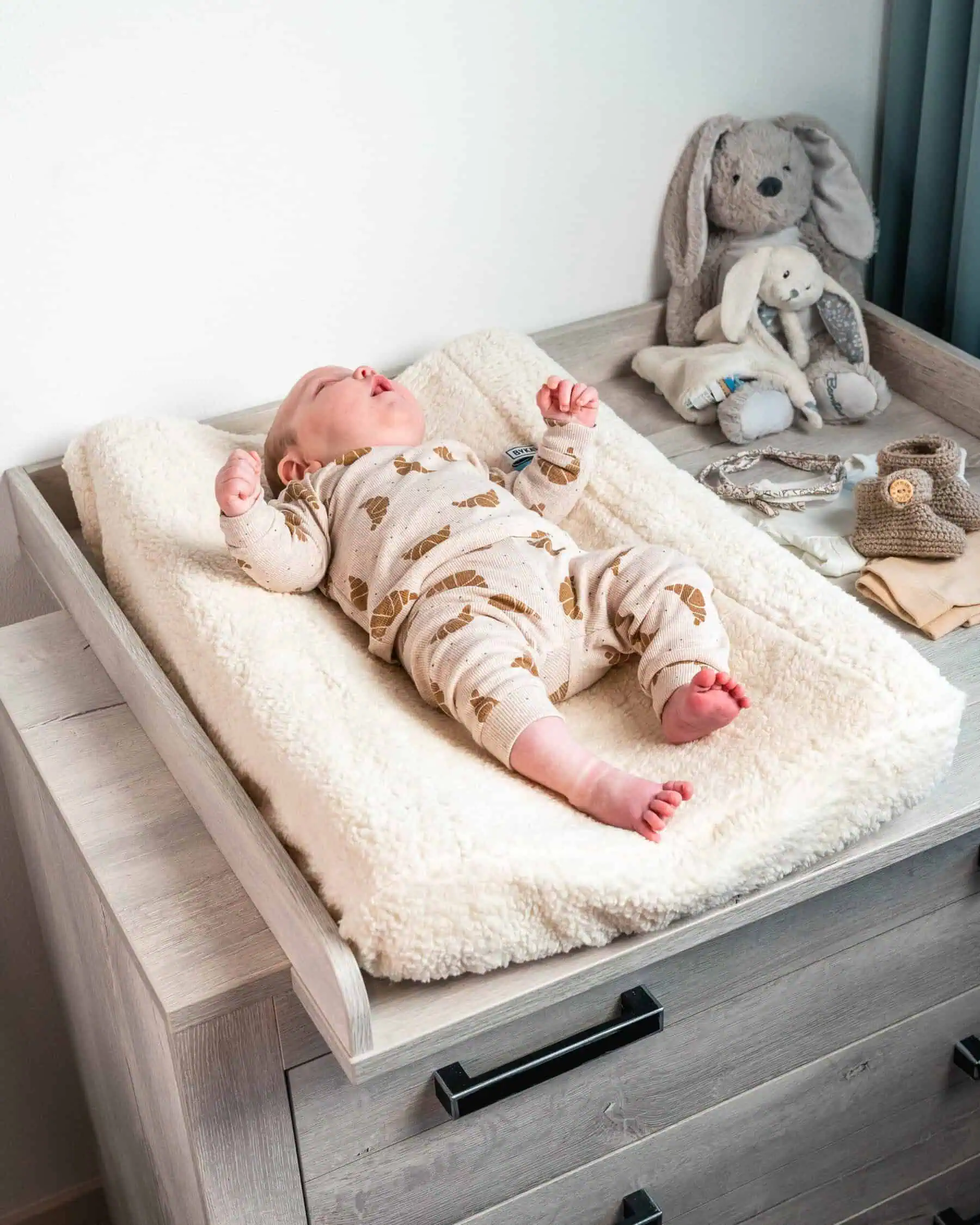 Baby lying comfortably on a changing pad