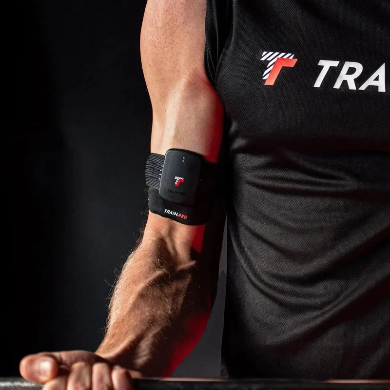 Train.Red FYER 2.0 sensor on athlete's arm during barbell lifting
